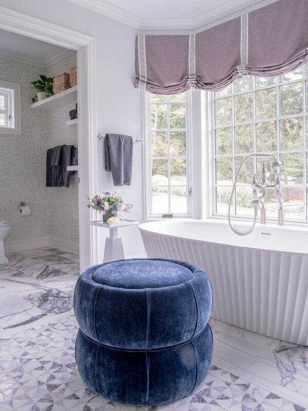 Soaking tub and blue ottoman