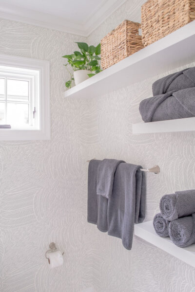 Powder room area with gray towels and greenery Powder room area with gray towels and greenery