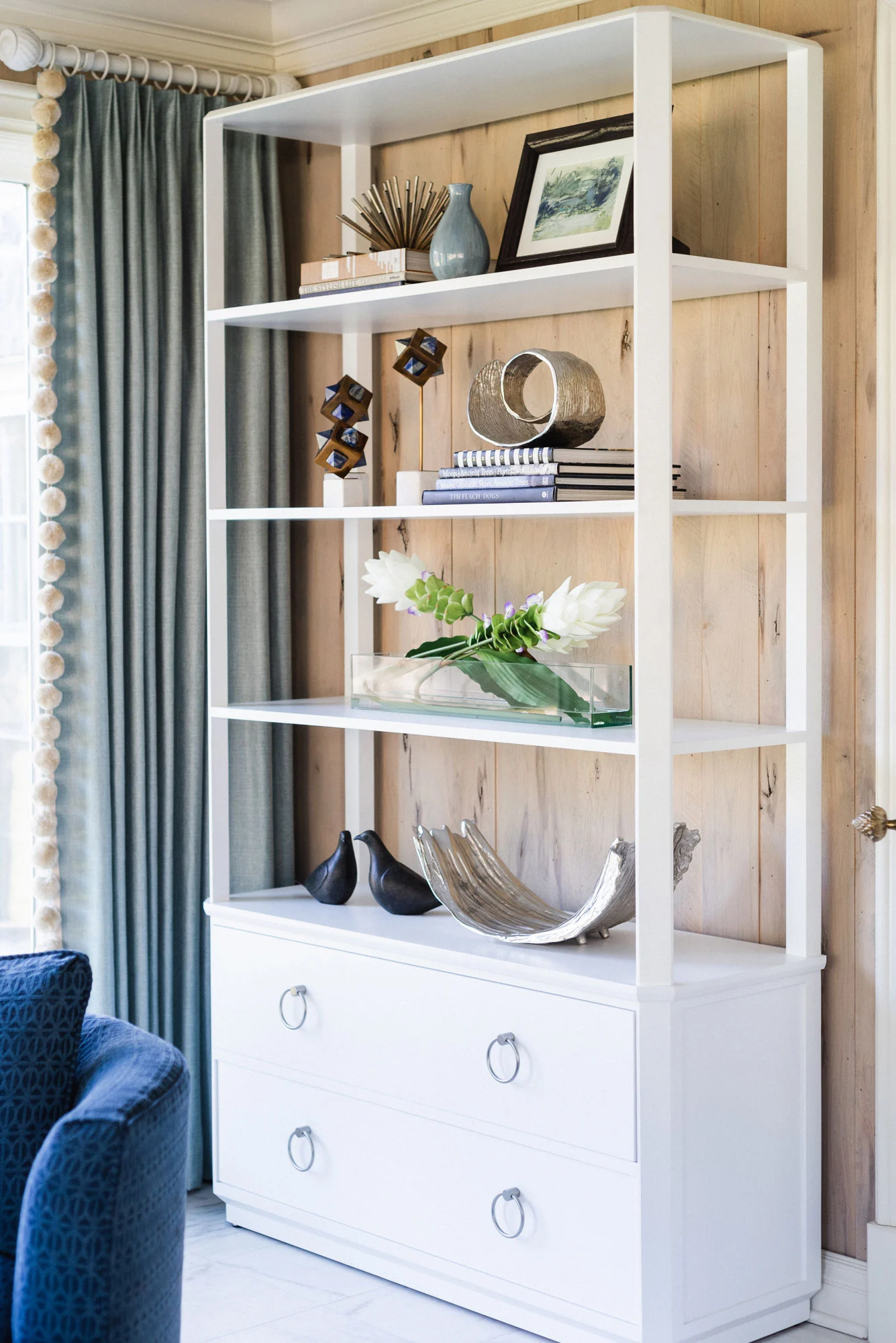 white open bookshelves styled with decorative objects