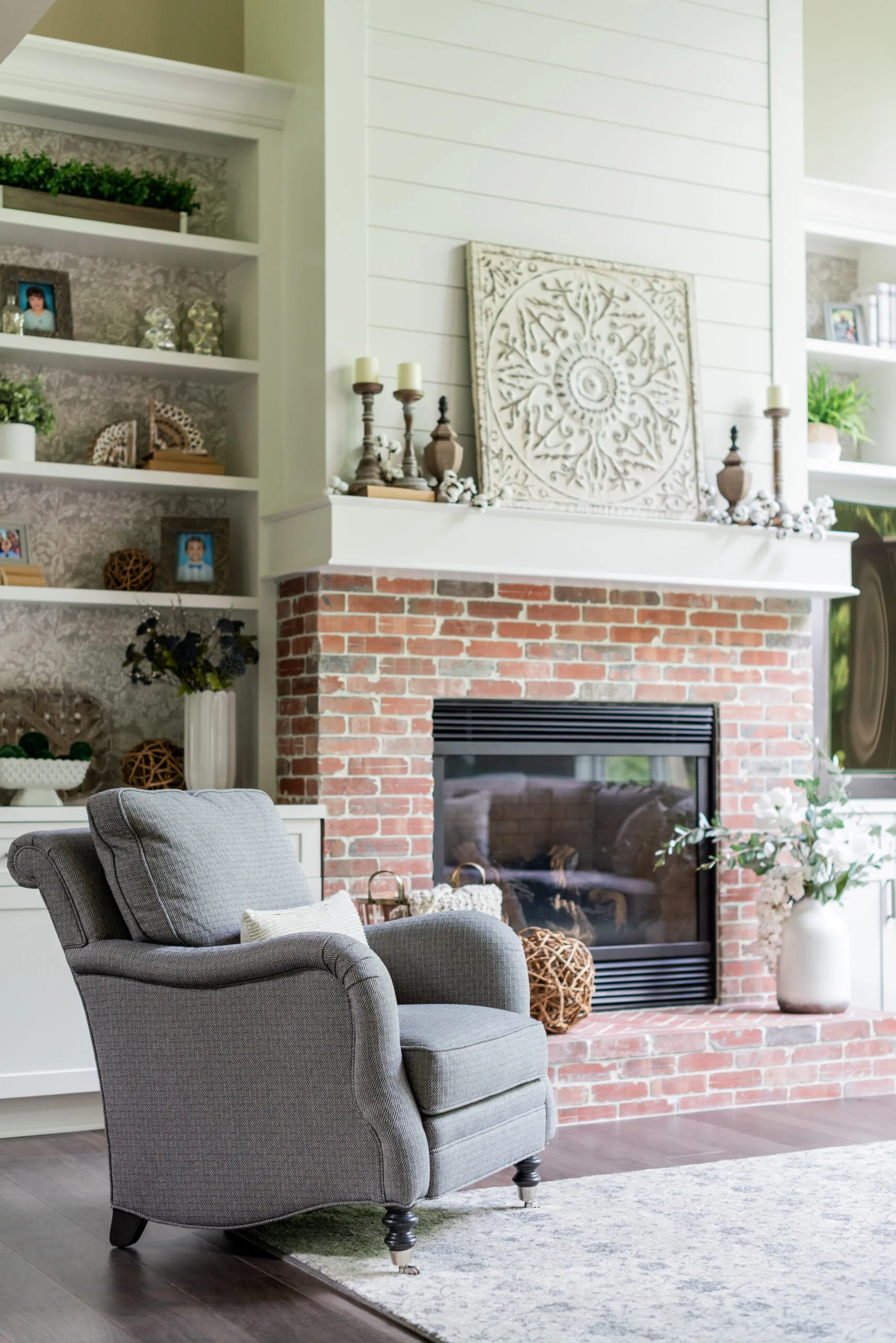 2 story great room with brick fireplace, built ins and sectional furniture