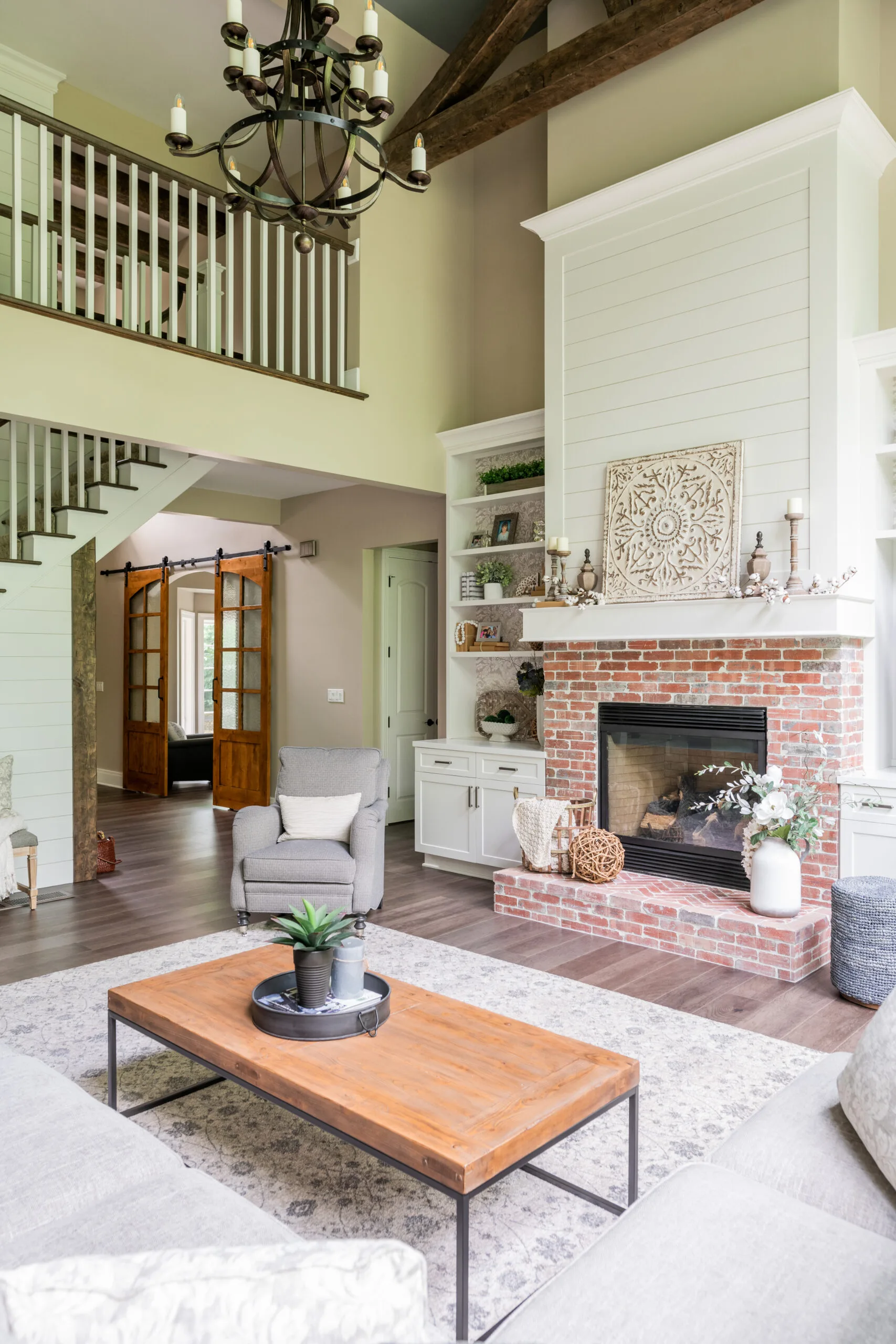2 story great room with brick fireplace, built ins and sectional furniture