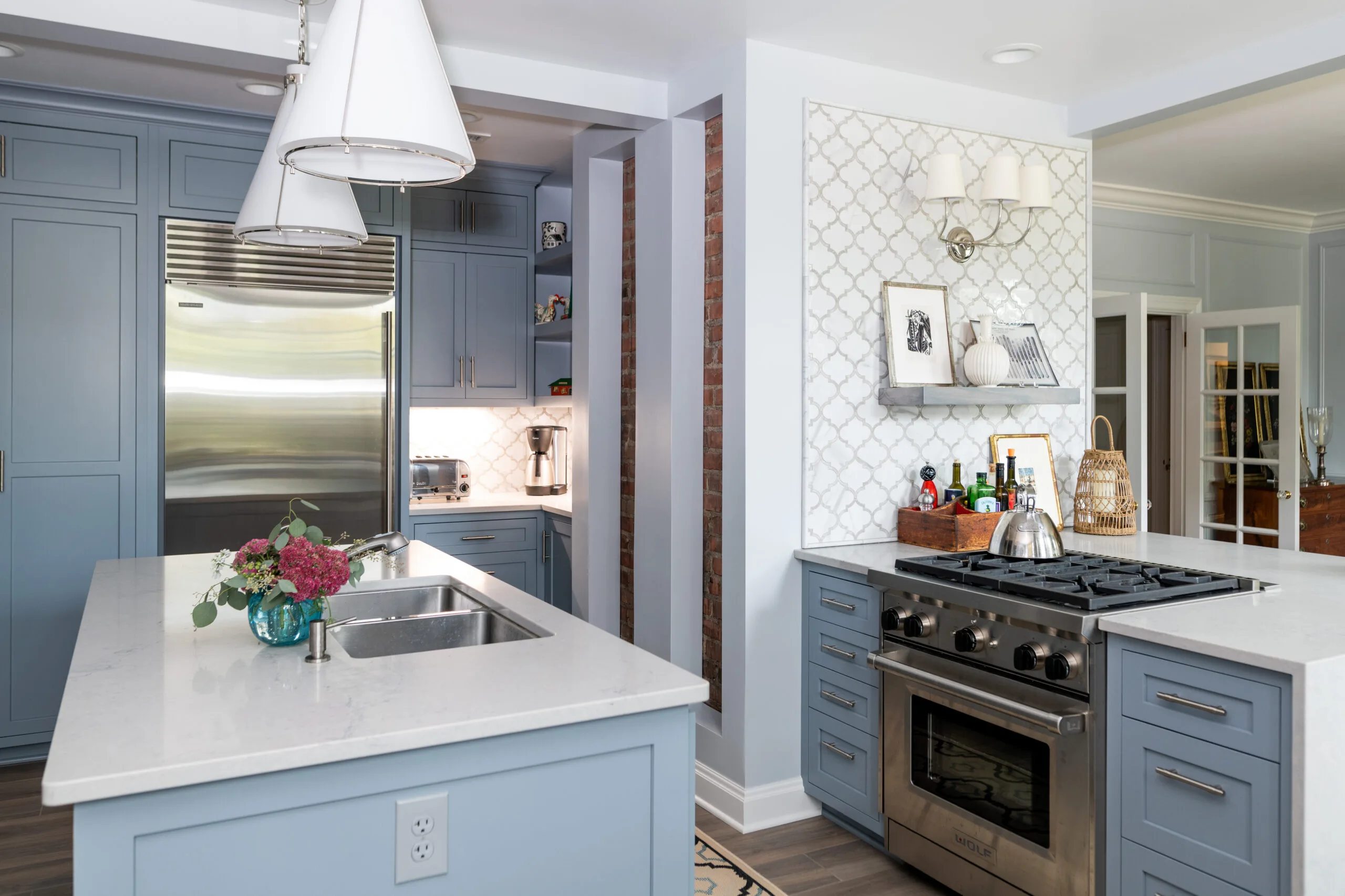 luxury kitchen appliances and painted cabinetry and modern pendant light