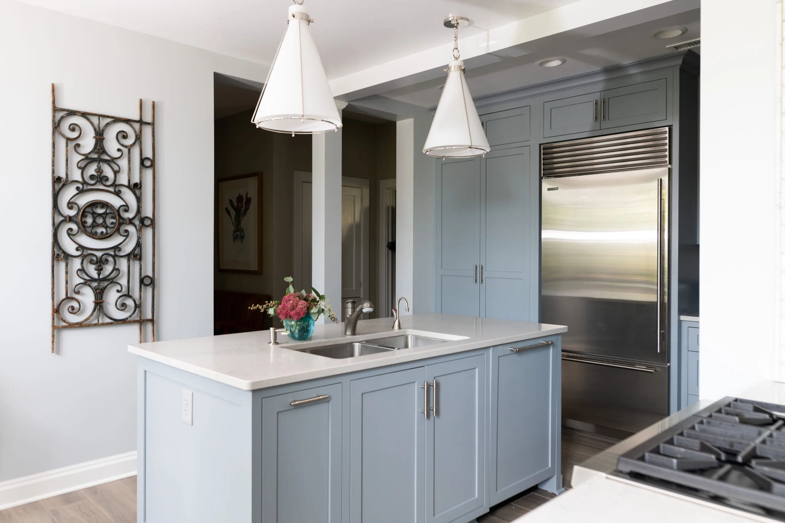 luxury kitchen appliances and painted cabinetry and modern pendant light