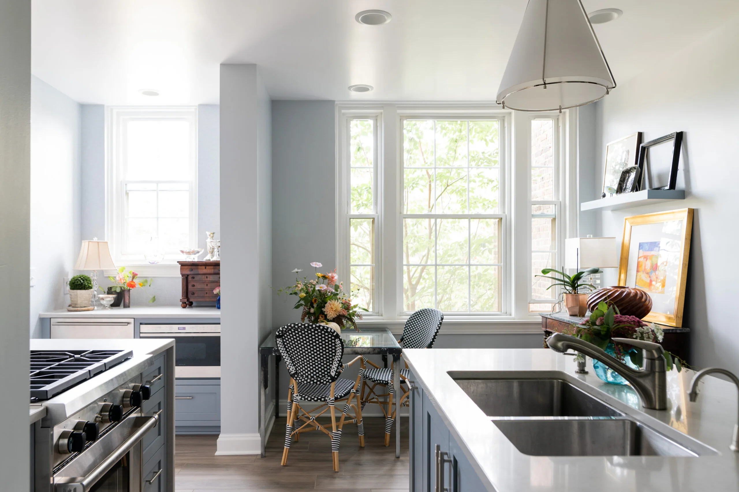 kitcen nook with curated accessories and blue french bistro style chairs