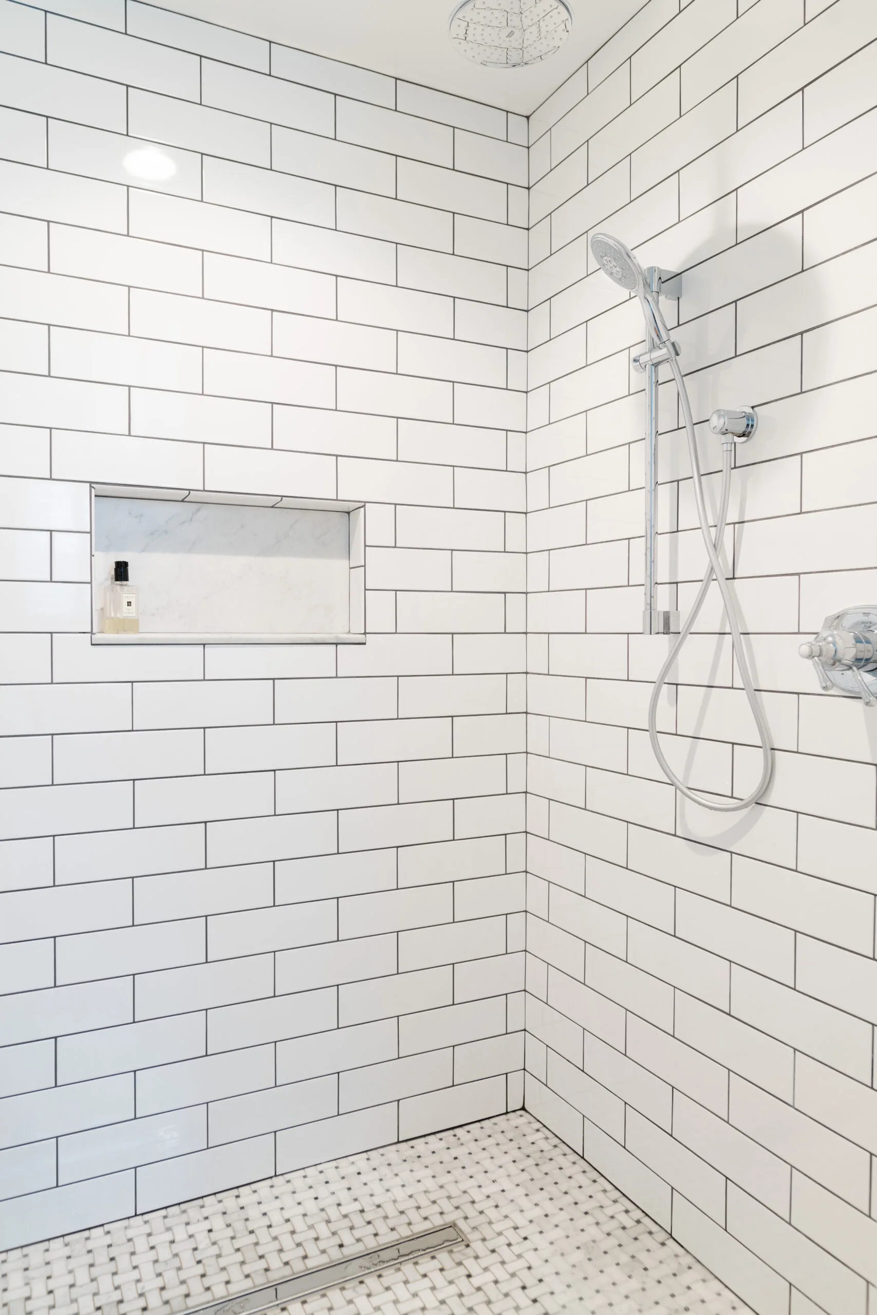 classic walk in shower with white subway tile