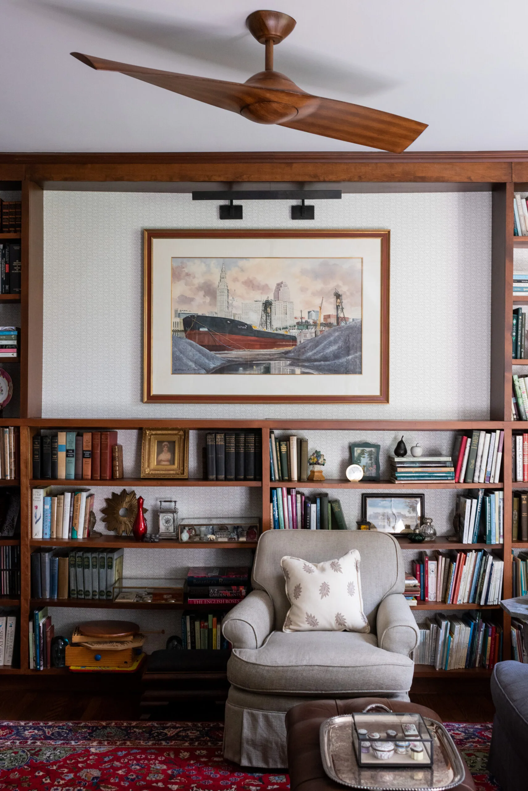 custom designed built in library storage, modern fan and unque art displayed in den