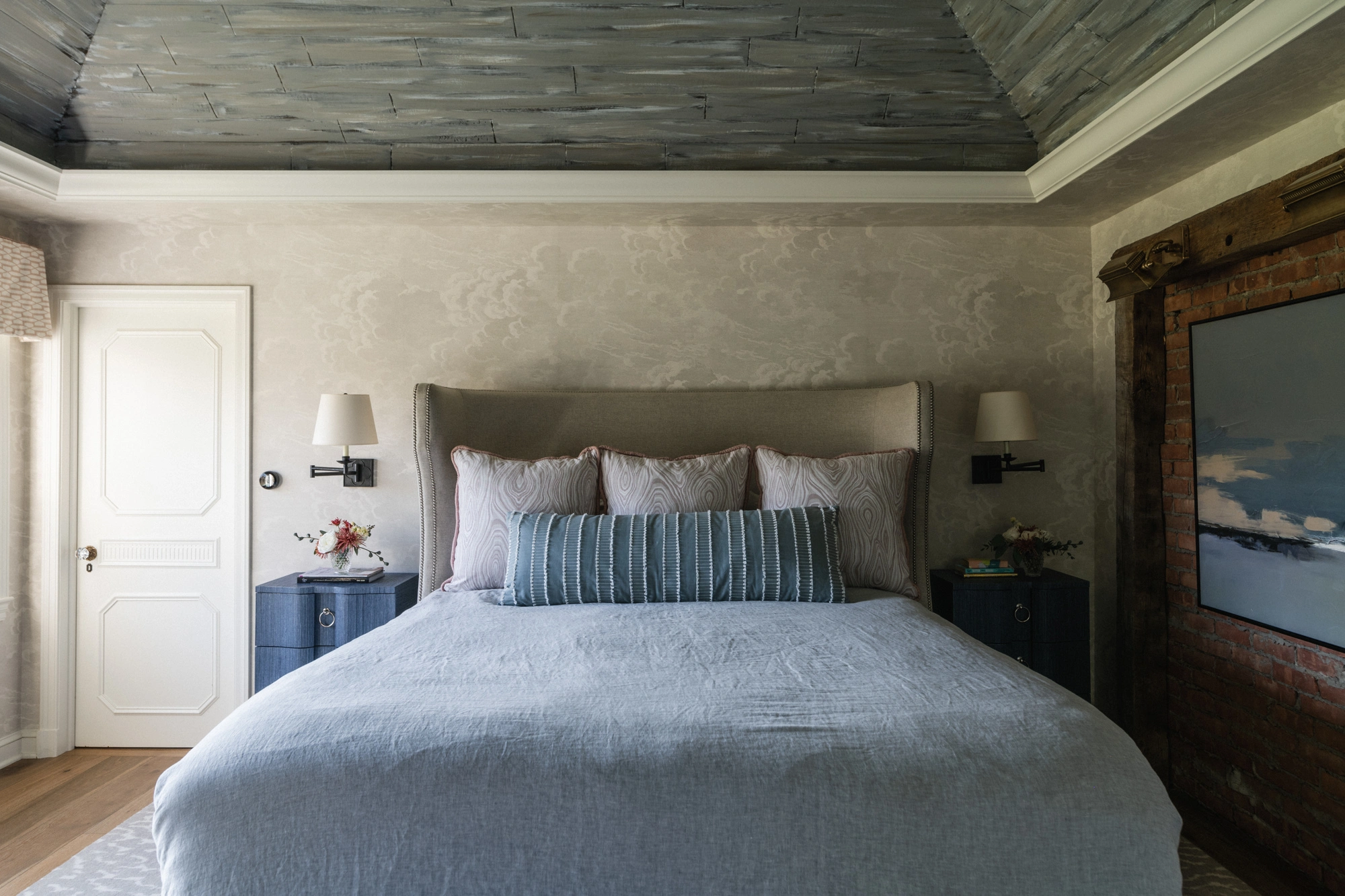 cozy bed with sconce lighting above nightstands