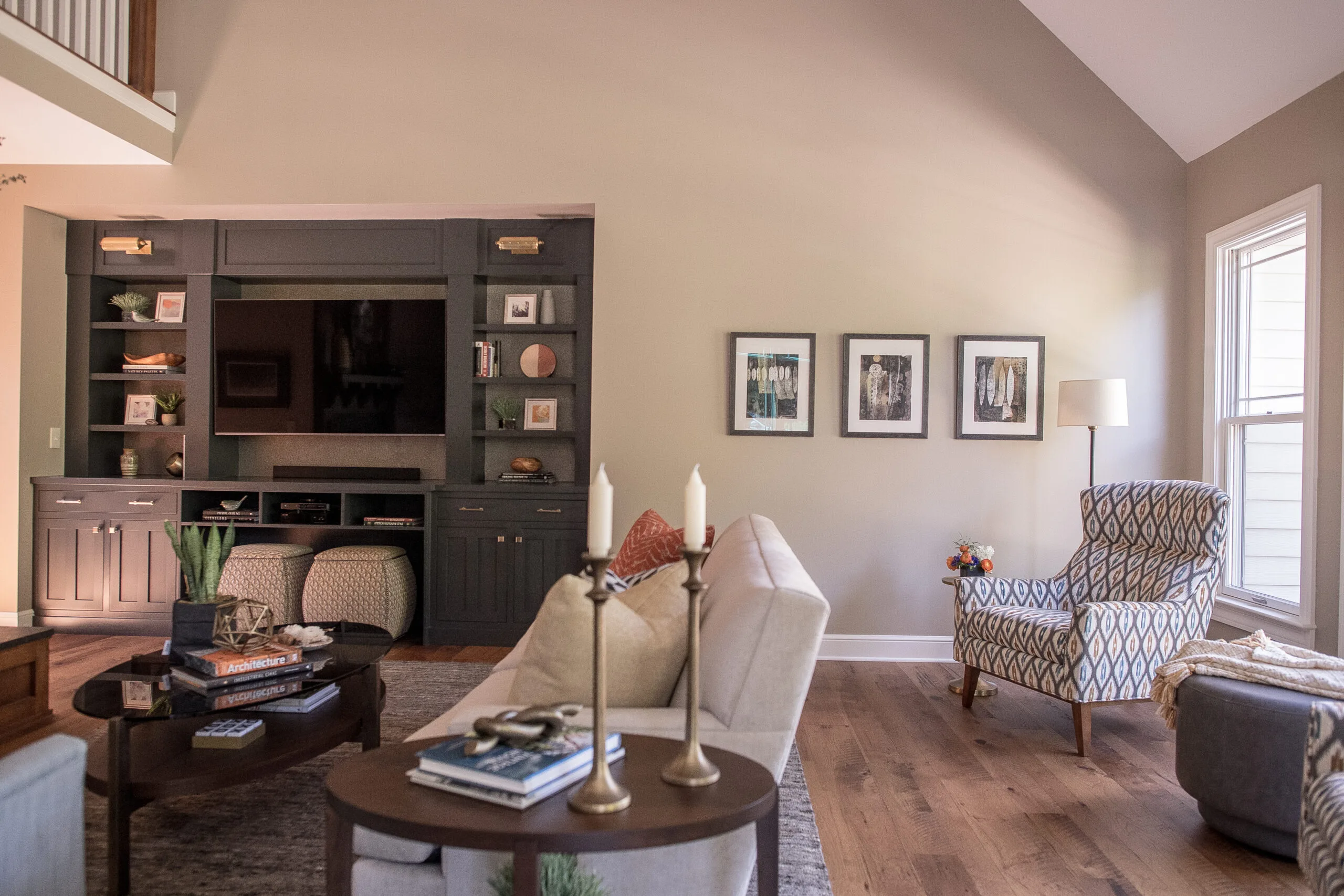 living room corner with artwork hanging and tv mounted