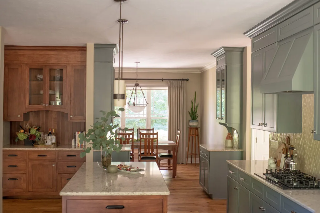 Kitchen counter with light cherry island and blue/green cabinets