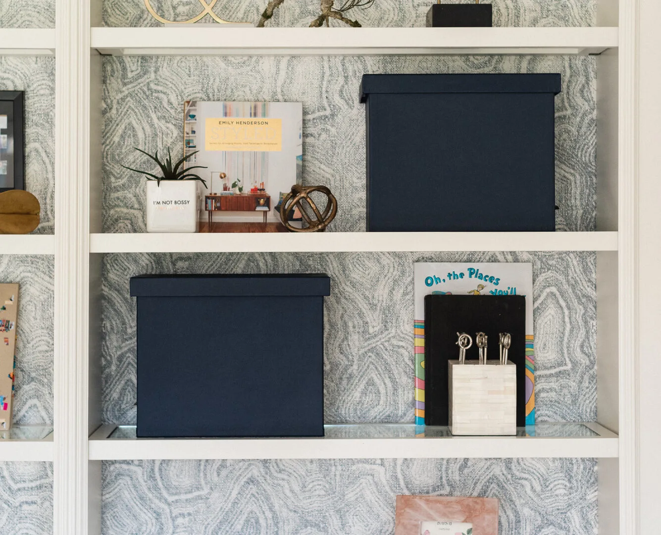 Bookshelf with wallpaper backing