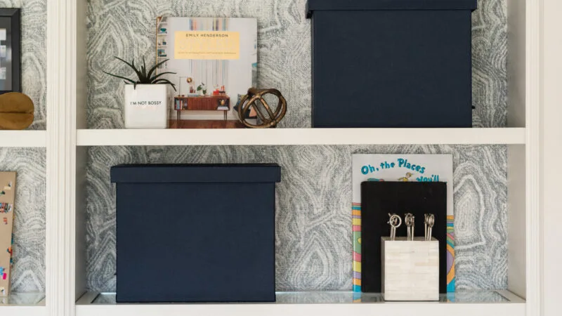 Bookshelf with wallpaper backing