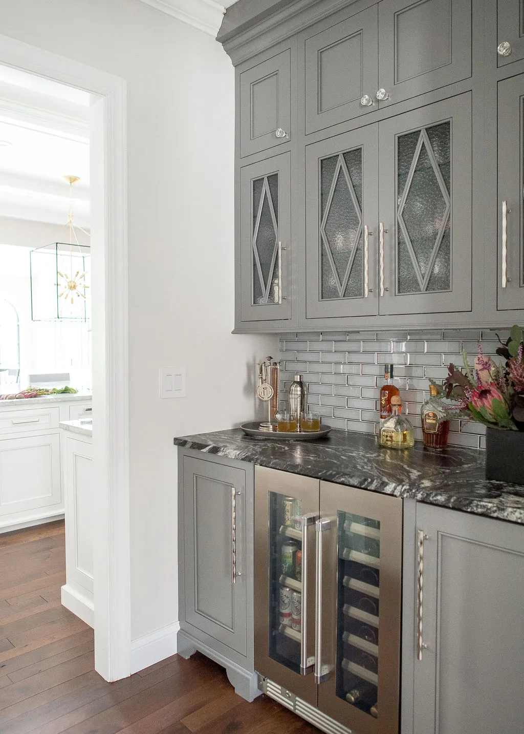 Built-in bar with beverage center and bar accessories on top of the counter
