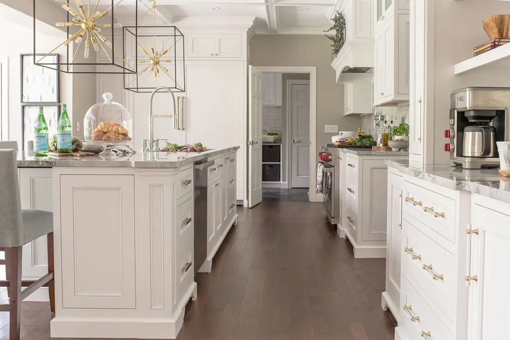 Neutral colored kitchen with traditional elements and dark hardwood floors