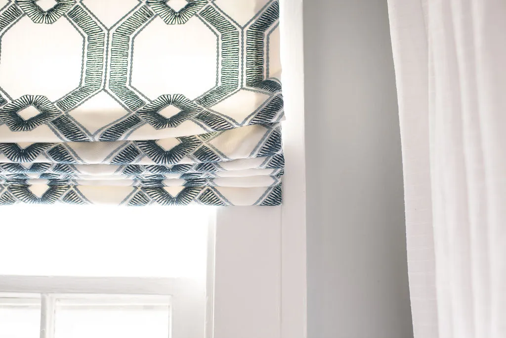 close up of patterned roman shades