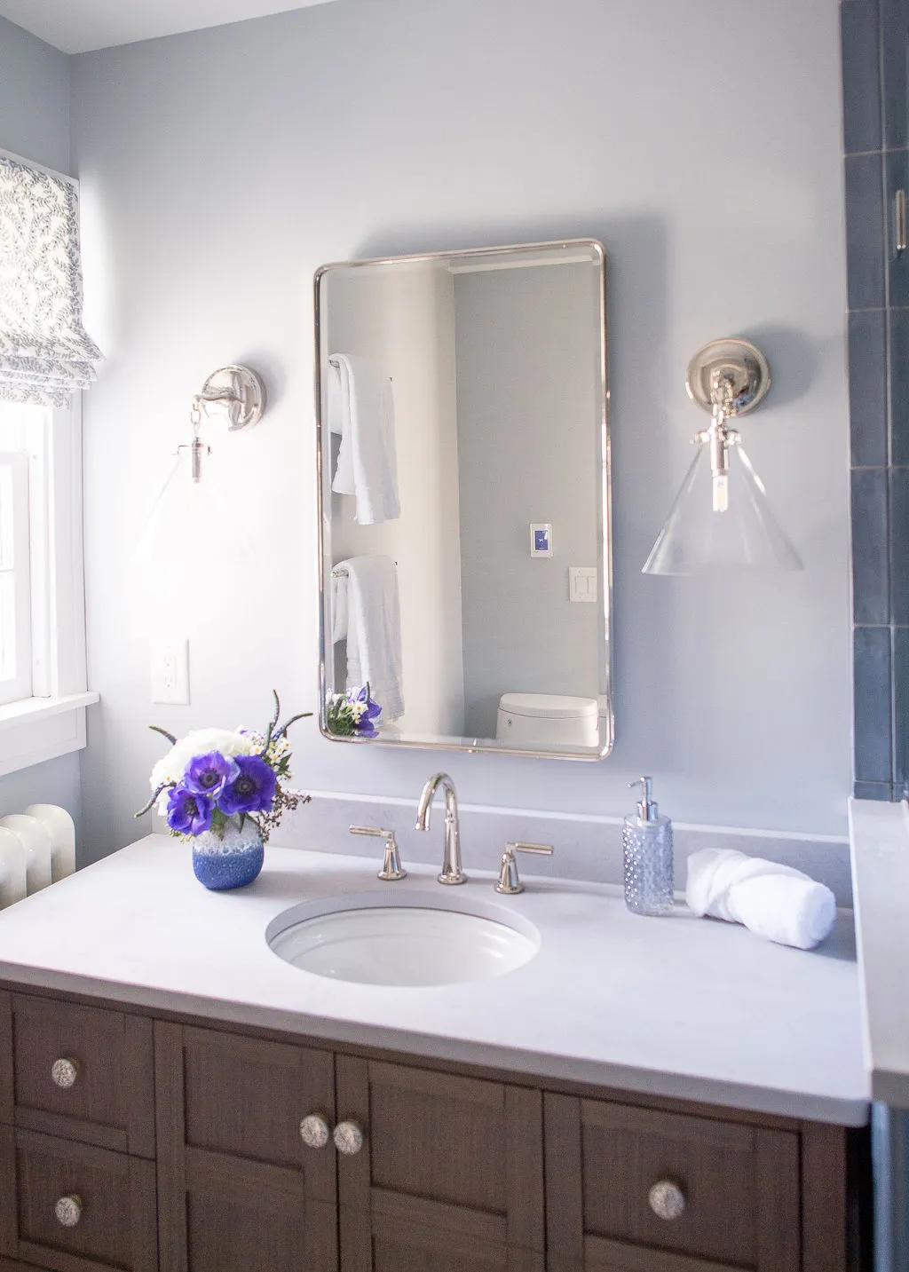 bathroom vanity with a dark, deep wood tone and fresh bright walls