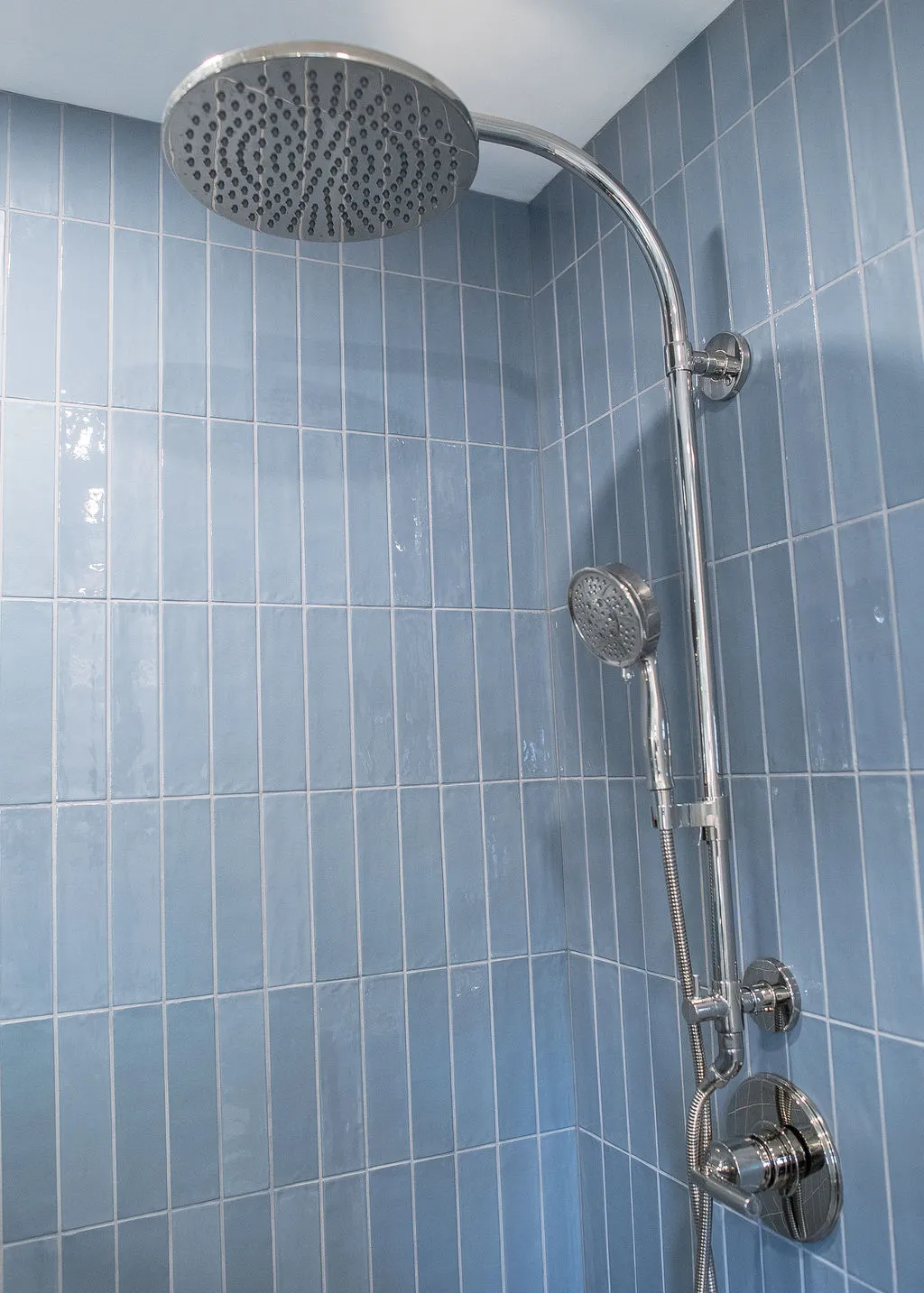 shower head and light blue shower tiles