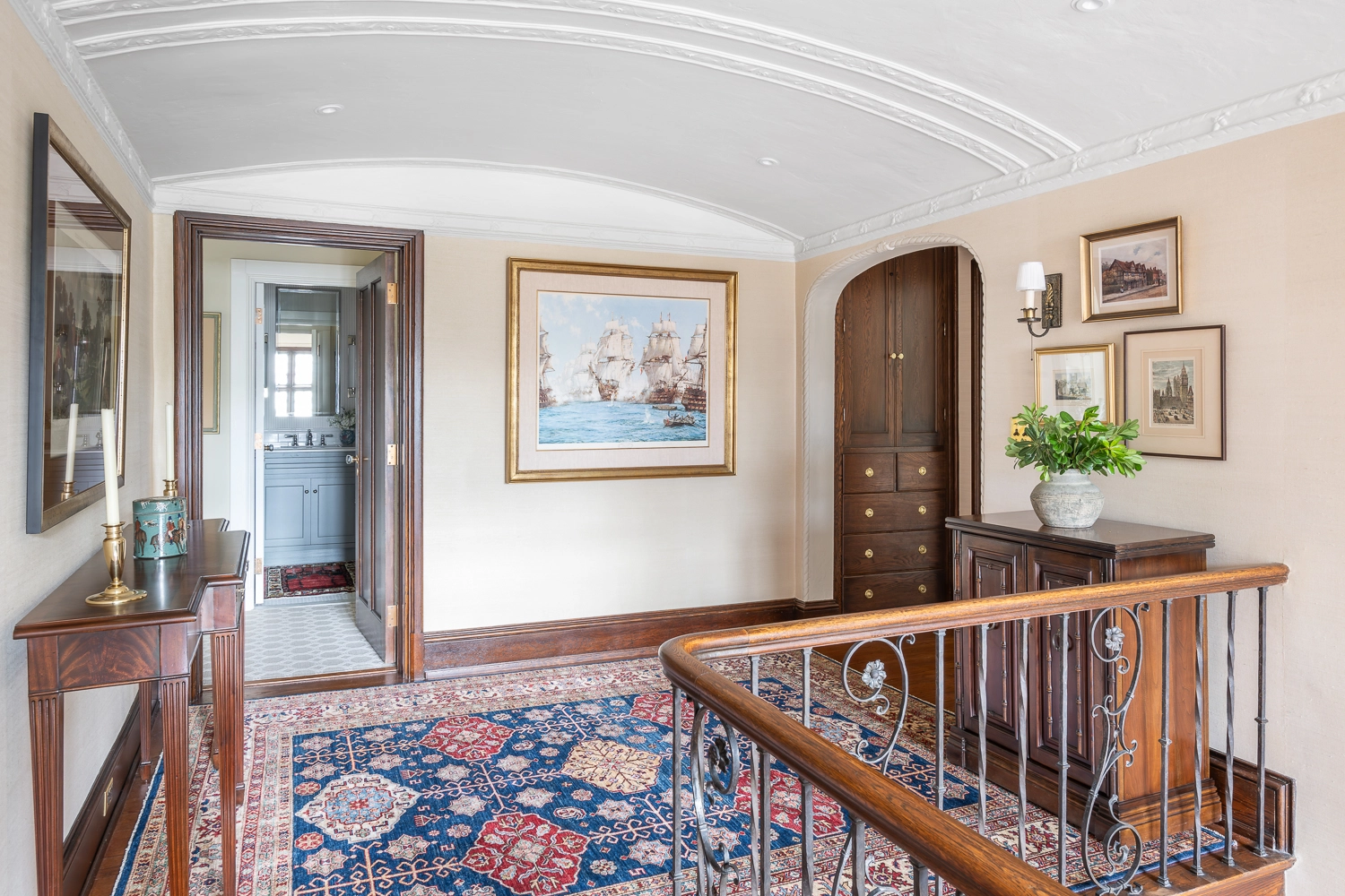 Foyer with a large oriental rug and a focus on the artwork across the room