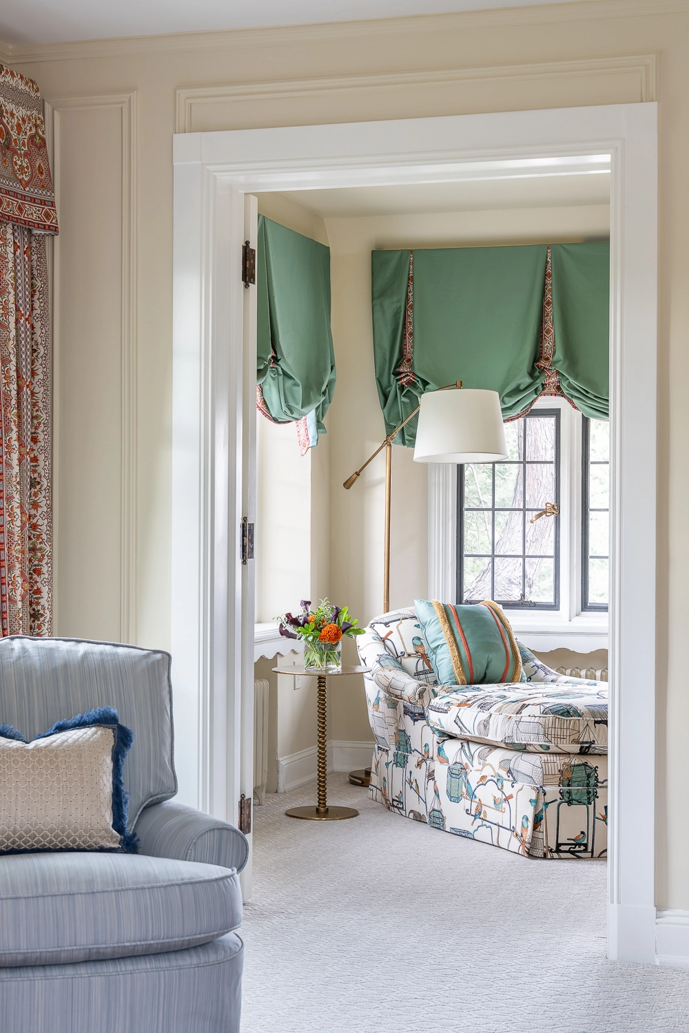 Image of a chaise lounge in front of windows with a valance