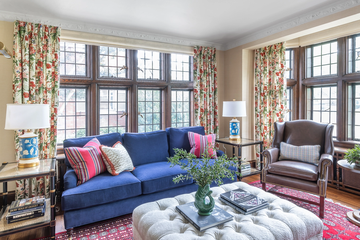 Image in a sitting room with a blue sofa and tufted ottoman