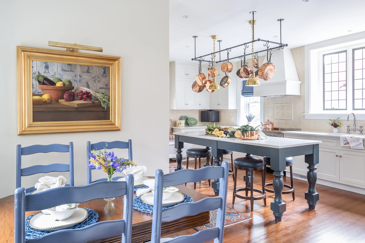 Image looking into a kitchen with a dining table tucked into a nook on the left