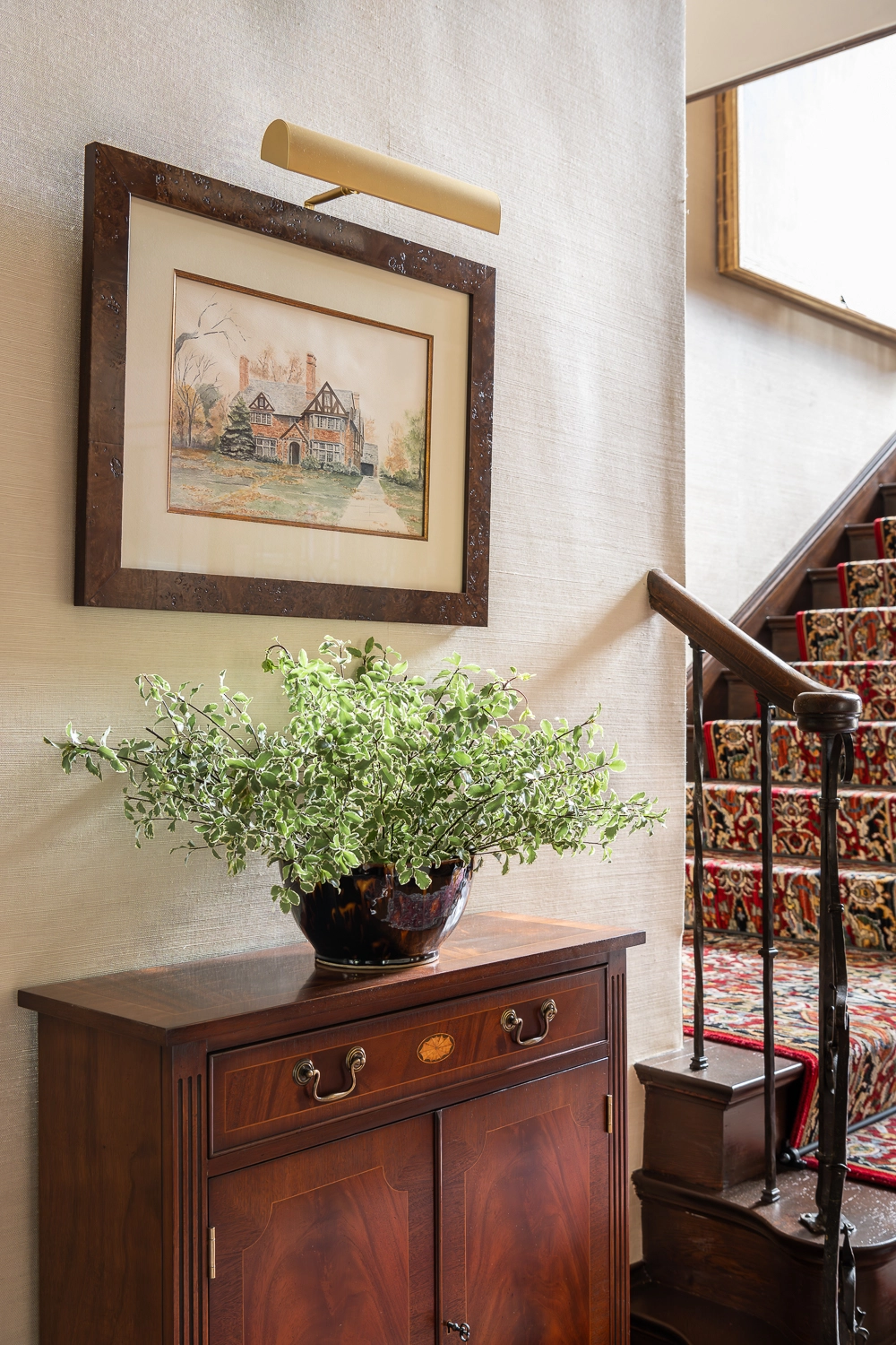 Image of traditional chest with greenery and artwork above