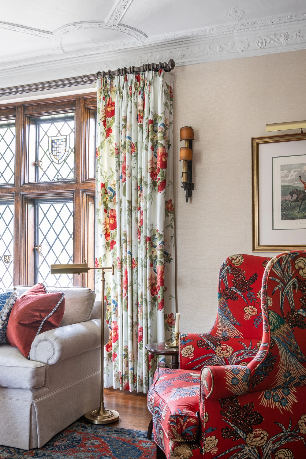 Image looking at one drapery panel on a window next to a sofa and side chair
