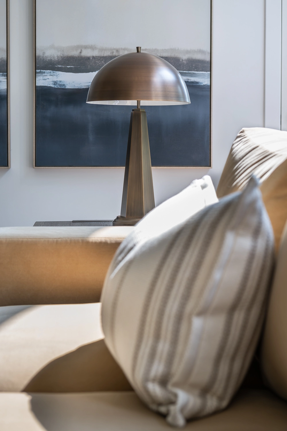 custom sofa pillow and modern blue and white abstract art with bronze lamp