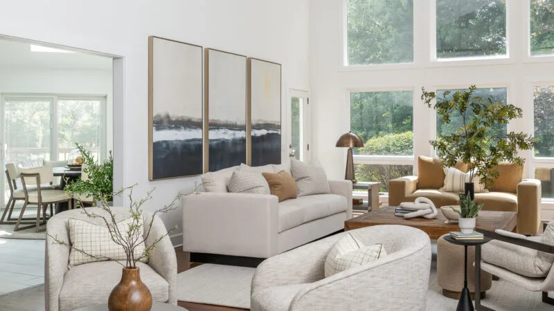 Great Room with modern plaster fireplace & neutral furniture