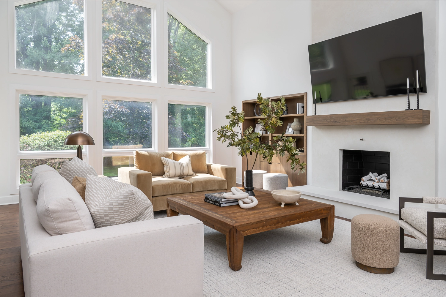 2 story living room with 2 custom sofas and large center coffee table and natrual branch arrangement