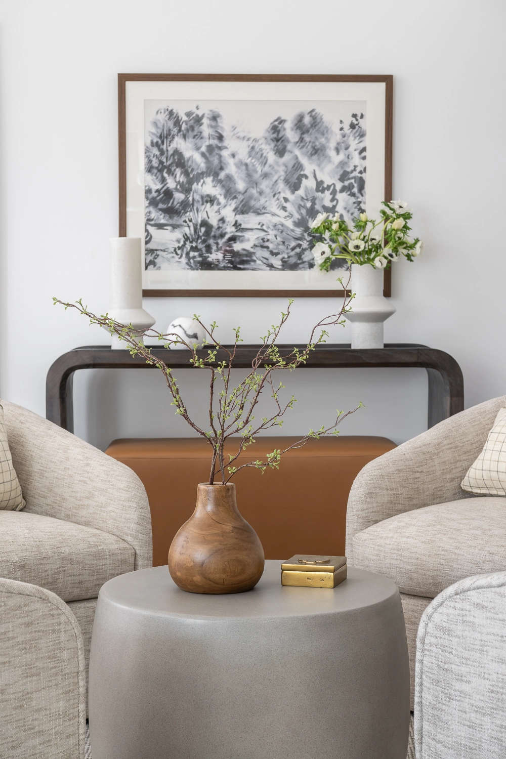 modern luxury console table with abstract artwork and marble vases