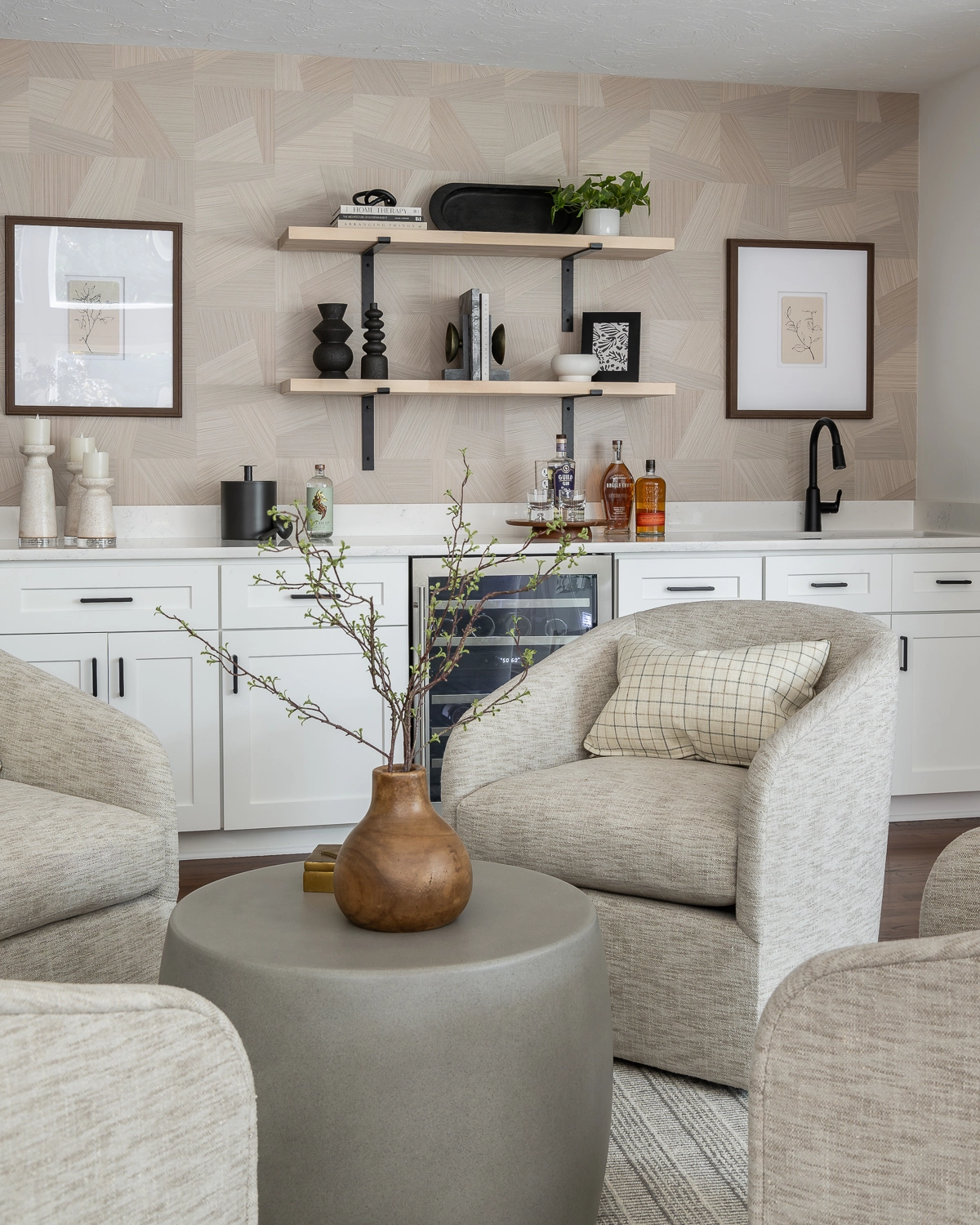 Luxury living room with conversation area of 4 chairs and concrete coffee table. Wet bar with wall shelves & accessories