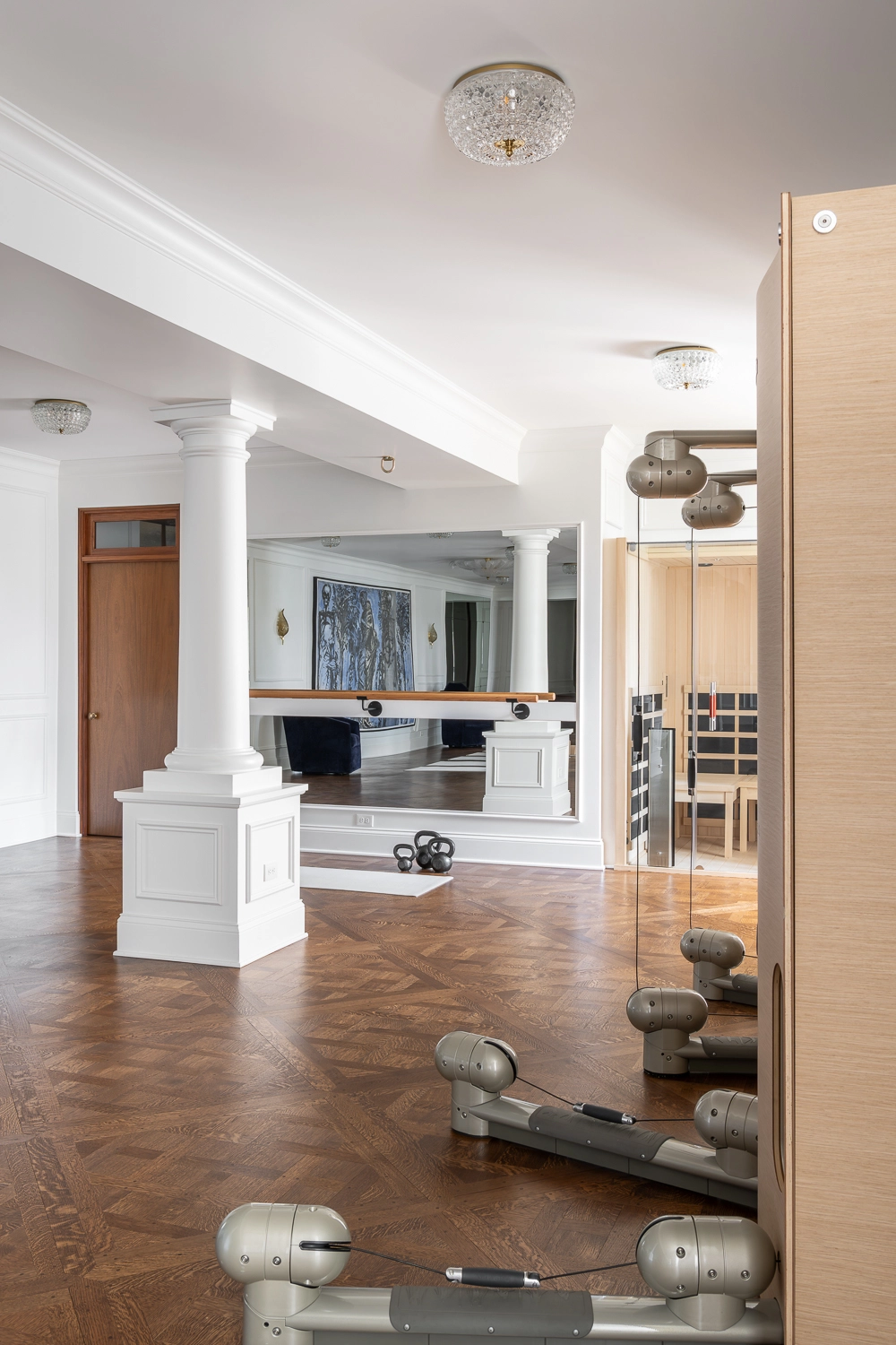 Luxury Home Gym with traditional millwork coumns and mirrors